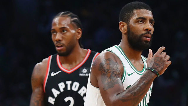BOSTON, MA - NOVEMBER 16: Kawhi Leonard #2 of the Toronto Raptors and Kyrie Irving #11 of the Boston Celtics look on during the first half at TD Garden on November 16, 2018 in Boston, Massachusetts.
