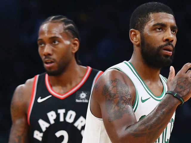 BOSTON, MA - NOVEMBER 16: Kawhi Leonard #2 of the Toronto Raptors and Kyrie Irving #11 of the Boston Celtics look on during the first half at TD Garden on November 16, 2018 in Boston, Massachusetts.