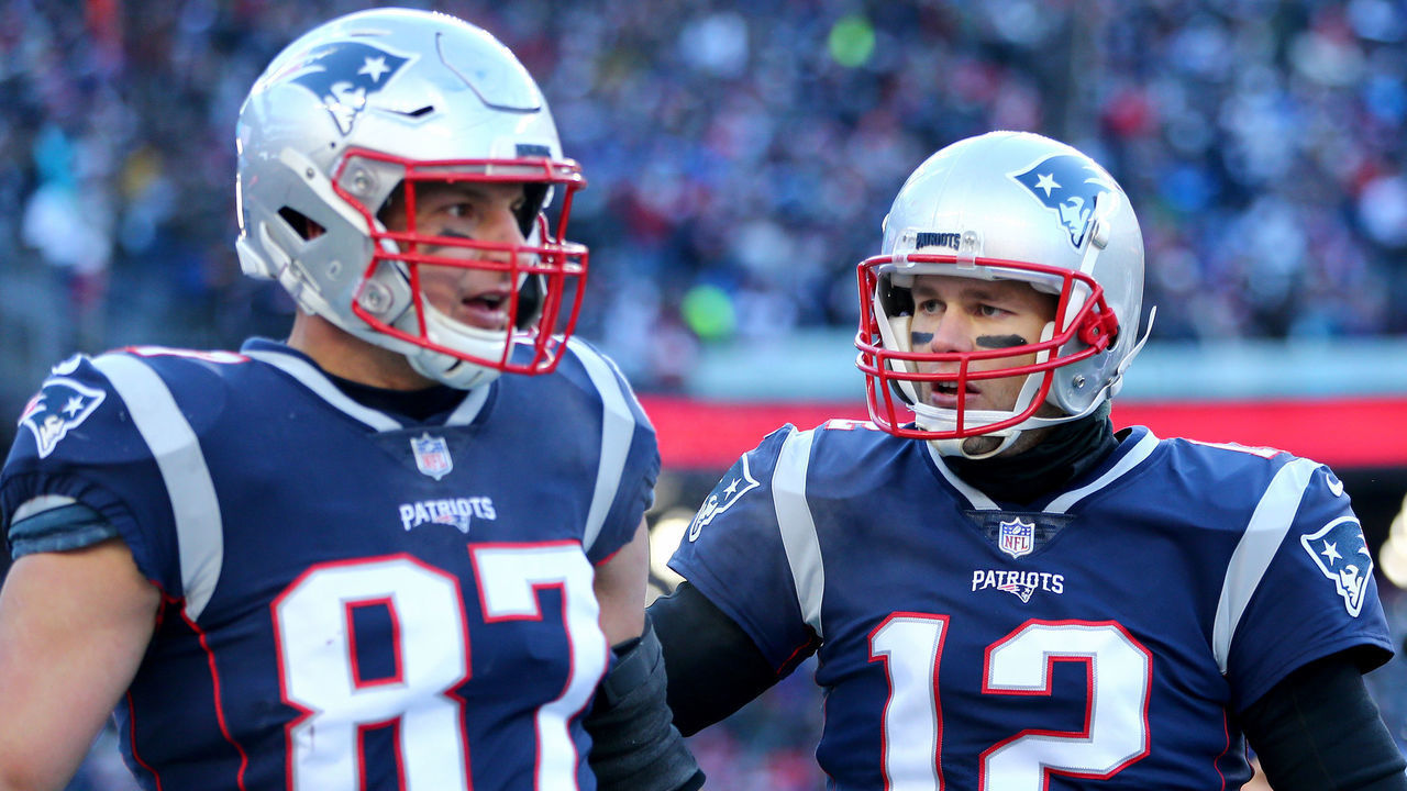 FOXBOROUGH, MASSACHUSETTS - JANUARY 13: Tom Brady #12 of the New England Patriots and Rob Gronkowski #87 react during the second quarter in the AFC Divisional Playoff Game against the Los Angeles Chargers at Gillette Stadium on January 13, 2019 in Foxborough, Massachusetts.