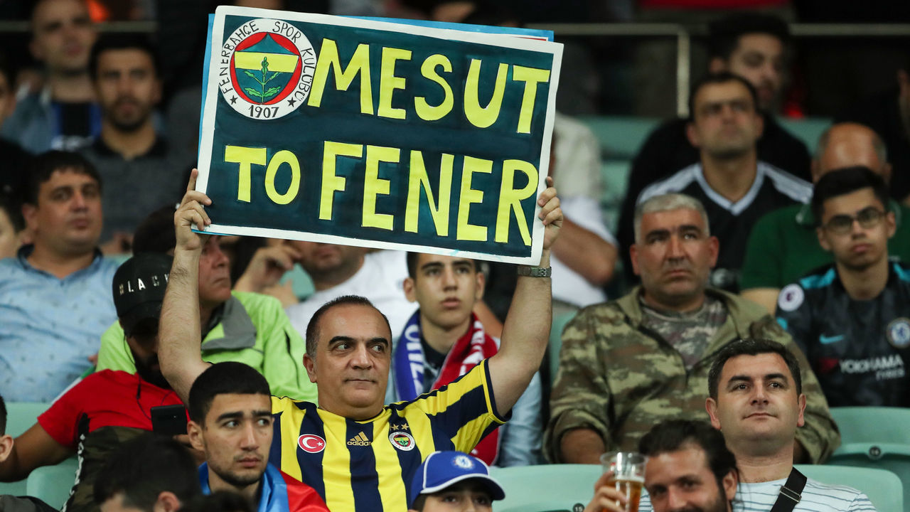 BAKU, AZERBAIJAN - MAY 29: A Fenerbache fan holds up a sign asking Mesut Ozil of Arsenal to join his club during the UEFA Europa League Final between Chelsea and Arsenal at Baku Olimpiya Stadionu on May 29, 2019 in Baku, Azerbaijan.