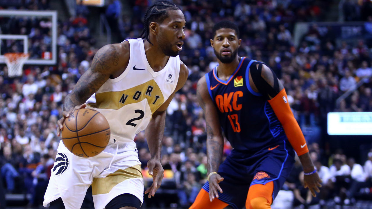 TORONTO, ON - MARCH 22: Kawhi Leonard #2 of the Toronto Raptors dribbles the ball as Paul George #13 of the Oklahoma City Thunder defends during the second half of an NBA game at Scotiabank Arena on March 22, 2019 in Toronto, Canada.
