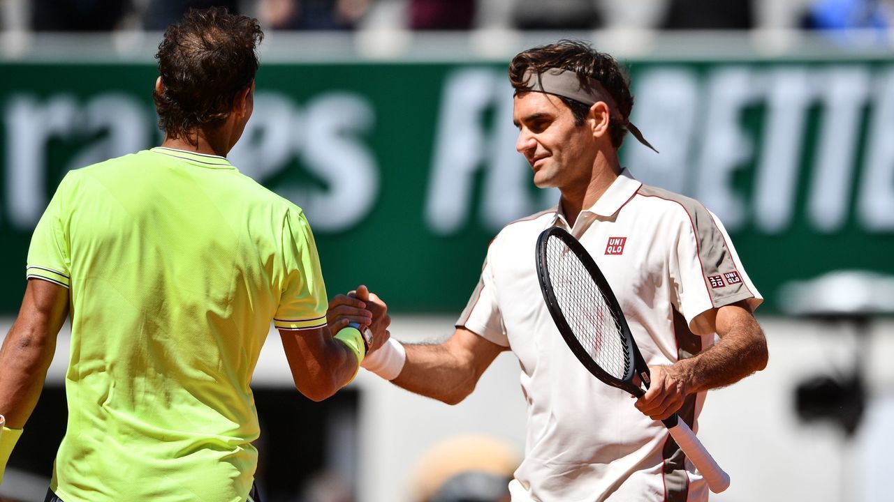 Spain's Rafael Nadal (R) and Switzerland's Roger Federer (L) shake hands at the end of their men's singles semi-final match on day 13 of The Roland Garros 2019 French Open tennis tournament in Paris on June 7, 2019.