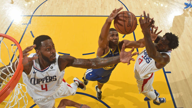 OAKLAND, CA - APRIL 24: Kevon Looney #5 of the Golden State Warriors battles for possession of the ball against JaMychal Green #4 and Patrick Beverley #21 of the LA Clippers during Game Five of Round One of the 2019 NBA Playoffs on April 24, 2019 at ORACLE Arena in Oakland, California. NOTE TO USER: User expressly acknowledges and agrees that, by downloading and or using this photograph, user is consenting to the terms and conditions of Getty Images License Agreement. Mandatory Copyright Notice: Copyright 2019 NBAE