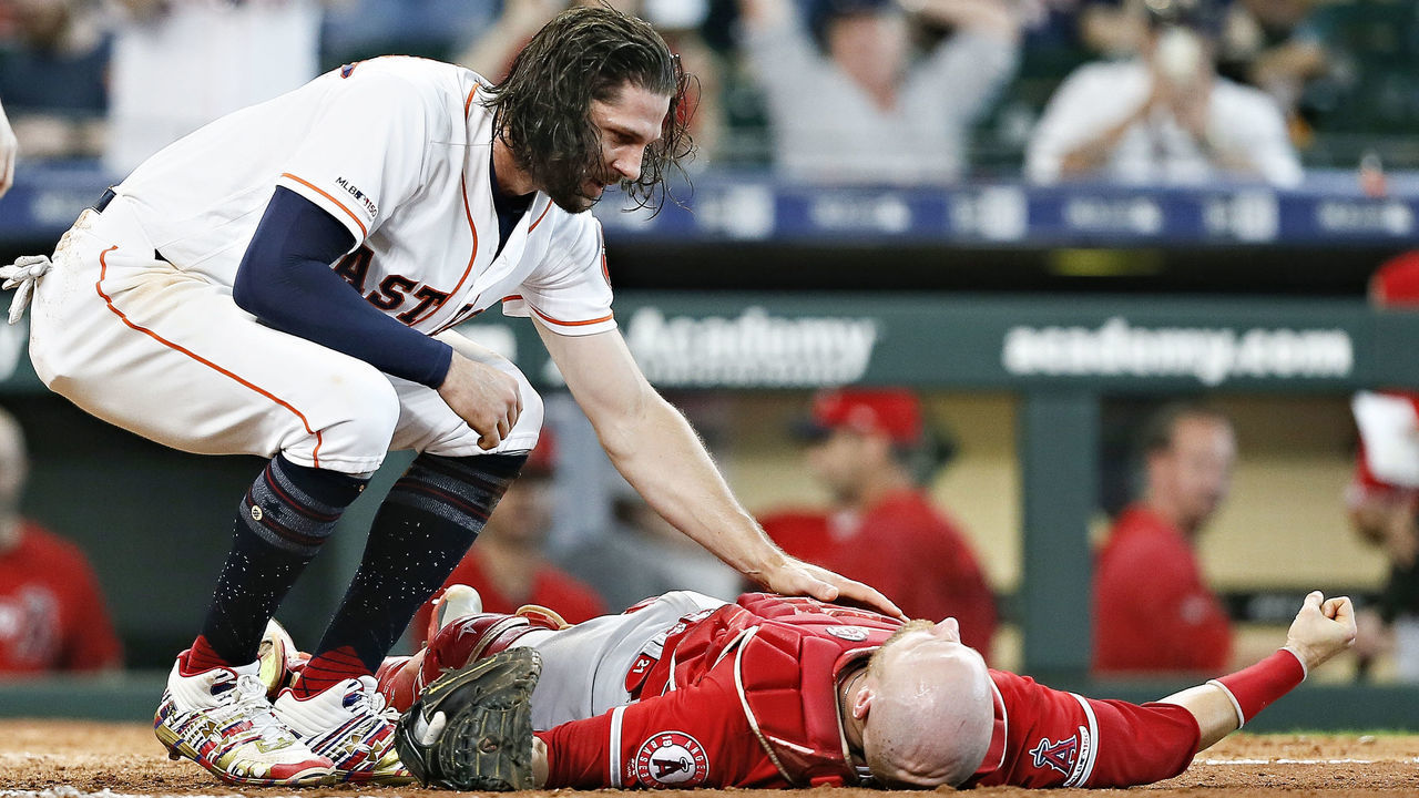 HOUSTON, TEXAS - JULY 07: Jake Marisnick #6 of the Houston Astros checks on Jonathan Lucroy #20 of the Los Angeles Angels of Anaheim after they collided in the eighth inning on a play at the plate at Minute Maid Park on July 07, 2019 in Houston, Texas. Marsnick was ruled out on the home plate collision rule.