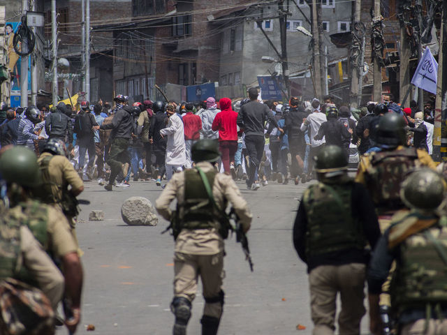 SRINAGAR, KASHMIR, INDIA - JUNE 05: : Kashmiri Muslim protester clash with Indian government forces during a protest against Indian rule, after prayers on Eid-ul-Fitr, a festival of Muslims on June 05, 2019 in Srinagar, the summer capital of Indian administered Kashmir, India. Suspected militants shot dead a Muslim woman on Wednesday in south Kashmirs Pulwama district, police said. Meanwhile dozens of Kashmir Muslim protesters were wounded after Indian government forces fired metal pellets at them when they took to streets chanting pro Kashmir freedom and 'anti-India' slogans, in protest against Indian rule and recent civilian killings. Thousands of Kashmiri Muslim clashed with Indian government forces after Eid prayers during anti Indian protests .Muslims all over the world are celebrating Eid ul-Fitr festival, a three-day celebration marking the end of the holy fasting month of Ramadan. A large number of Indian government forces were deployed on the streets by the Indian authorities in Kashmir to thwart anti-India protest on the occasion of Eid-ul-Fitr a Muslim festival.