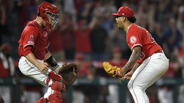 ANAHEIM, CA - JULY 12: Dustin Garneau #45 of the Los Angeles Angels of Anaheim runs out to conratulate Felix Pena #45 of the Los Angeles Angels of Anaheim on a combined no-htter against the Seattle Mariners at Angel Stadium of Anaheim on July 12, 2019 in Anaheim, California. The entire Angels team wore Tyler Skaggs #45 jersey to honor him after his death on July 1. Angels won 13-0.