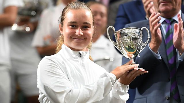 Ukraine's Daria Snigur poses with the girl's singles winners trophy on day twelve of the 2019 Wimbledon Championships at The All England Lawn Tennis Club in Wimbledon, southwest London, on July 13, 2019.