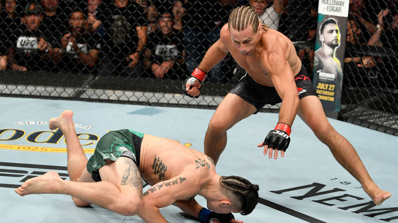 SACRAMENTO, CALIFORNIA - JULY 13: (R-L) Urijah Faber drops Ricky Simon in their bantamweight bout during the UFC Fight Night event at Golden 1 Center on July 13, 2019 in Sacramento, California.