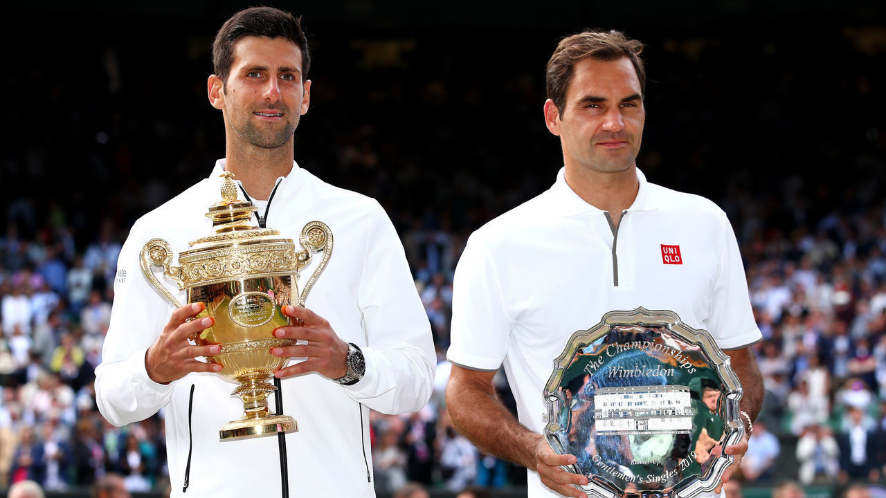 LONDON, ENGLAND - JULY 14: Novak Djokovic of Serbia and Roger Federer of Switzerland pose for a photo with their trophies after the Men's Singles final during Day thirteen of The Championships - Wimbledon 2019 at All England Lawn Tennis and Croquet Club on July 14, 2019 in London, England.