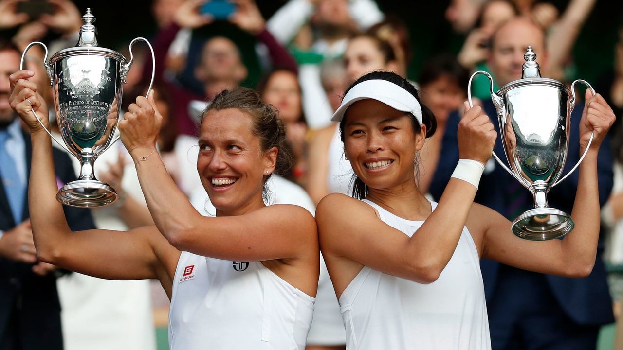 Czech Republic's Barbora Strycova (L) and Taiwan's Hsieh Su-Wei (R) celebrate with their winners trophies after beating Canada's Gabriela Dabrowski and China's Xu Yifan in the women's doubles final on day thirteen of the 2019 Wimbledon Championships at The All England Lawn Tennis Club in Wimbledon, southwest London, on July 14, 2019.