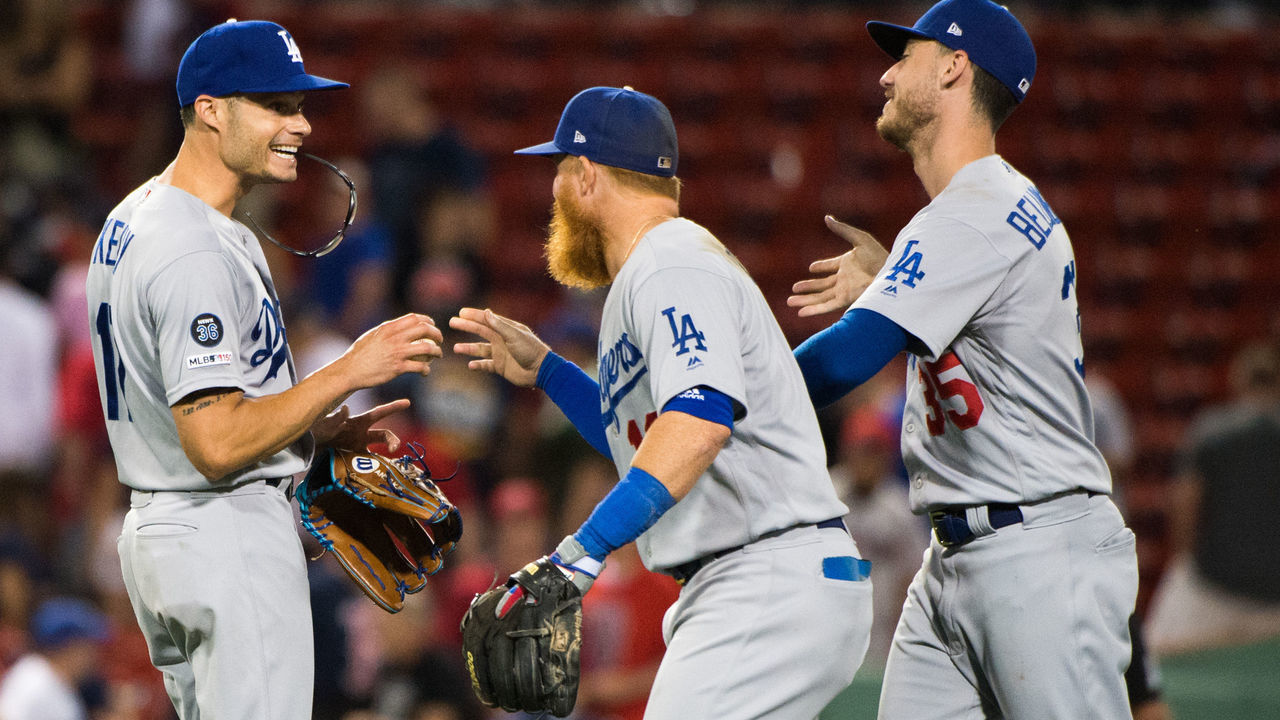BOSTON, MA - JULY 15: Joe Kelly #17 celebrates with teammates Justin Turner #10 and Cody Bellinger #35 of the Los Angeles Dodgers after beating the Boston Red Sox in twelve innings at Fenway Park on July 15, 2019 in Boston, Massachusetts.