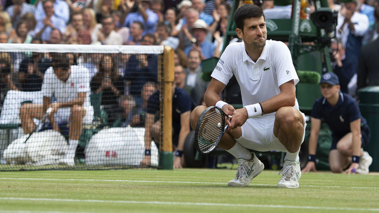 LONDON, ENGLAND - JULY 14: Novak Djokovic of Serbia walks back out on to court and takes a moment to reflect after beating Roger Federer of Switzerland in the Final of the Gentlemen's Singles on Day Thirteen of The Championships - Wimbledon 2019 at All England Lawn Tennis and Croquet Club on July 14, 2019 in London, England.