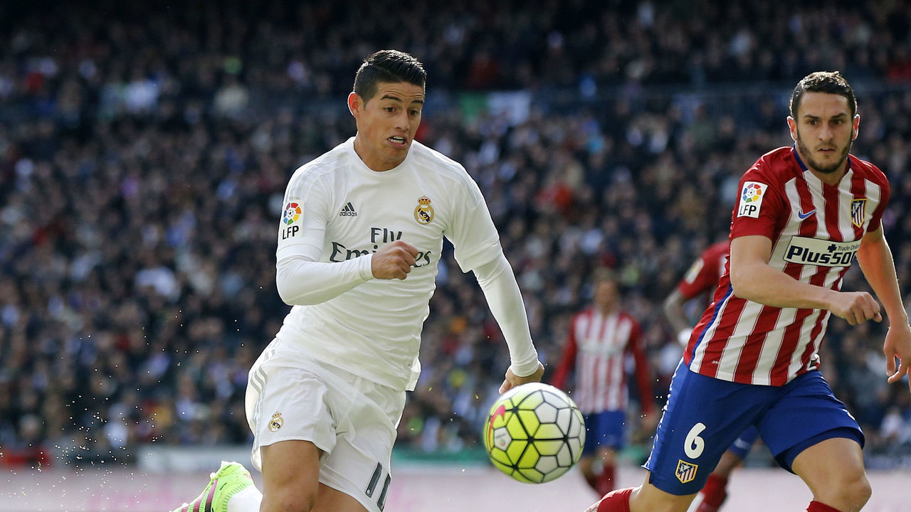 MADRID, SPAIN - FEBRUARY 27: James Rodriguez of Real Madrid competes for the ball with Koke of Atletico de Madrid during the La Liga match between Real Madrid CF and Club Atletico de Madrid at Estadio Santiago Bernabeu on February 27, 2016 in Madrid, Spain.