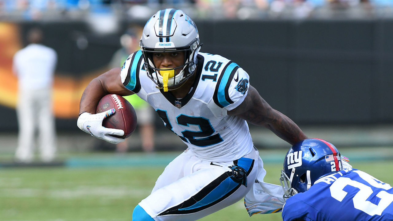 CHARLOTTE, NC - OCTOBER 07: Carolina Panthers wide receiver DJ Moore (12) breaks the tackle by New York Giants cornerback Eli Apple (24) during the NFL game between the New York Giants and the Carolina Panthers on October 07, 2018 at Bank of America Stadium in Charlotte,NC.