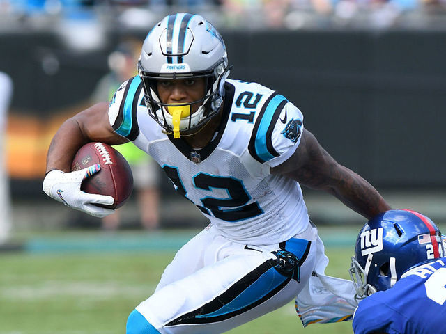 CHARLOTTE, NC - OCTOBER 07: Carolina Panthers wide receiver DJ Moore (12) breaks the tackle by New York Giants cornerback Eli Apple (24) during the NFL game between the New York Giants and the Carolina Panthers on October 07, 2018 at Bank of America Stadium in Charlotte,NC.
