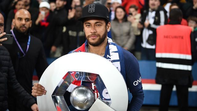 Paris Saint-Germain's Brazilian forward Neymar celebrates with the champion's trophy at the end of the French L1 football match between Paris Saint-Germain (PSG) and Dijon at the Parc des Princes stadium in Paris on May 18, 2019.