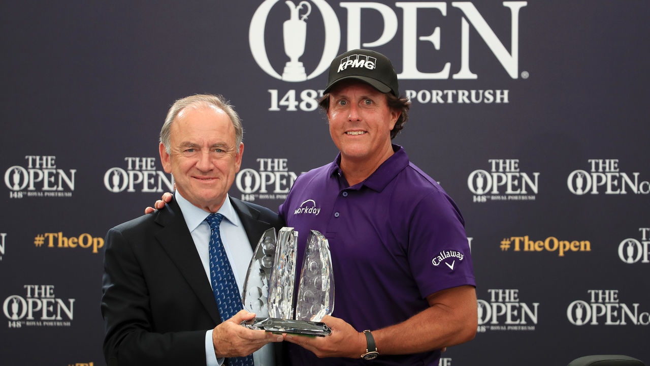 PORTRUSH, NORTHERN IRELAND - JULY 16: Official World Golf Ranking Chairman Peter Dawson presents Phil Mickelson of The United States with an award for spending the last 25 years in the top 50 best ranked players in the World official ranking during a practice round prior to the 148th Open Championship held on the Dunluce Links at Royal Portrush Golf Club on July 16, 2019 in Portrush, United Kingdom.