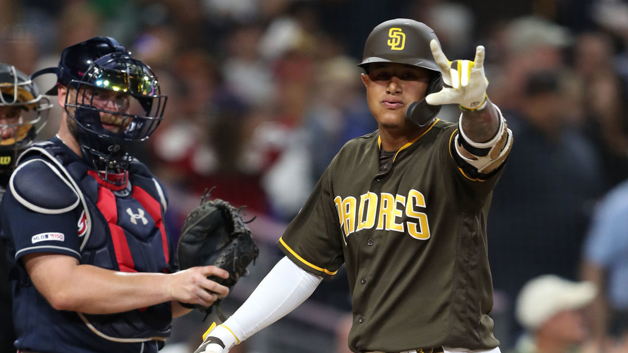 SAN DIEGO, CALIFORNIA - JULY 12: Manny Machado #13 of the San Diego Padres reacts to hitting a solo homerum as Brian McCann #16 of the Atlanta Braves looks on during the sixth inning of a game at PETCO Park on July 12, 2019 in San Diego, California.