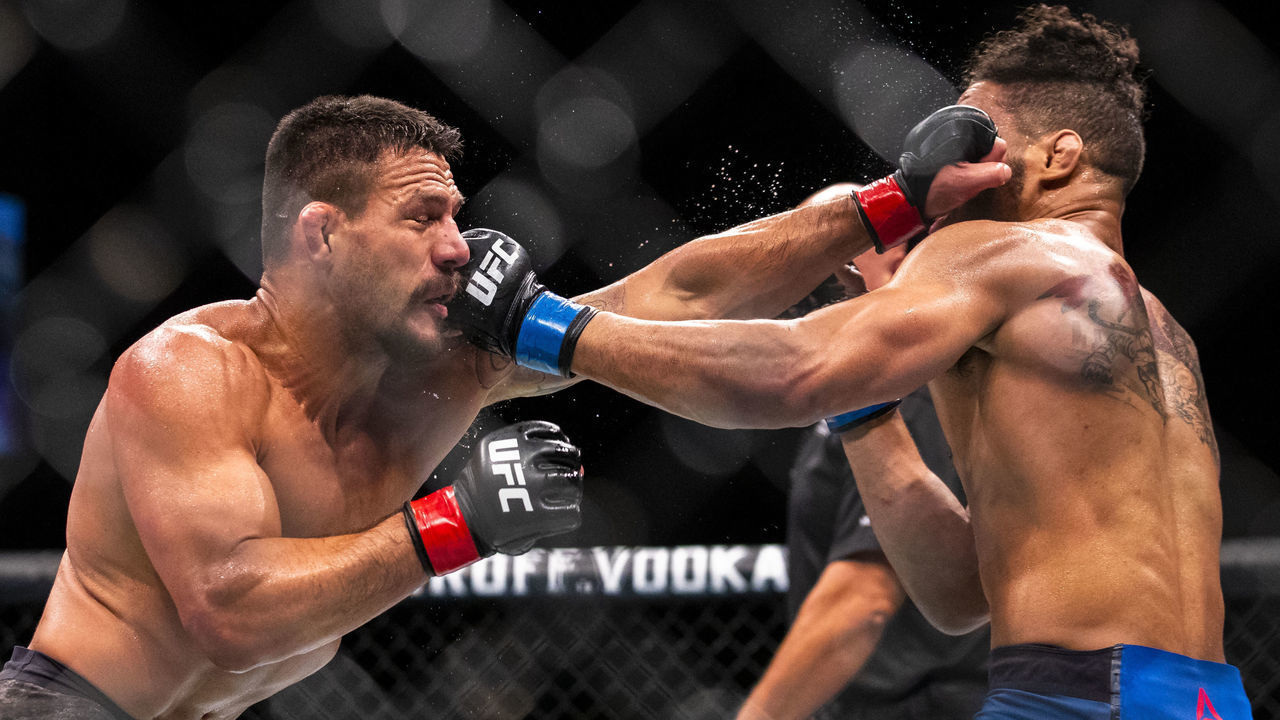 ROCHESTER, NY - MAY 18: Rafael Dos Anjos (left) and Kevin Lee (right) trade blows during round three of a welterweight bout at Blue Cross Arena on May 18, 2019 in Rochester, New York. Dos Anjos defeats Lee by submission during the third round.