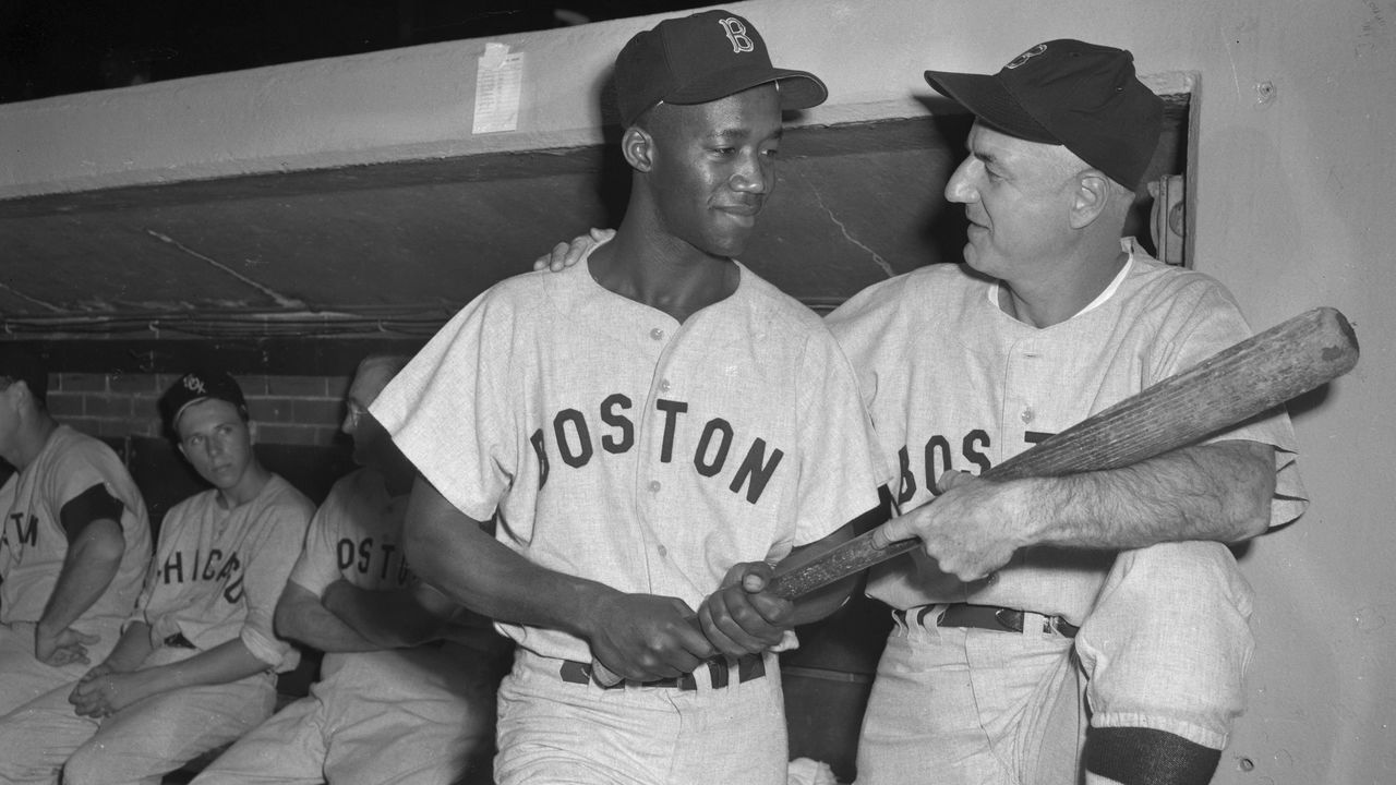 (Original Caption) Manager Bill Jurges, (R) of the Boston Red Sox, greets Pumpsie Green, who was recalled to the parent club from Minneapolis. Green, an infielder, became the first African American ever to play for the Red Sox when he came in as pinch runner in the 8th inning of the game. The White Sox won 2-1.