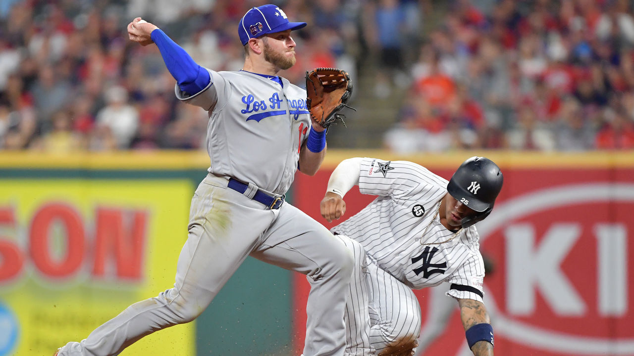 CLEVELAND, OHIO - JULY 09: Gleyber Torres #25 of the New York Yankees slides as Max Muncy #13 of the Los Angeles Dodgers looks to throw during the 2019 MLB All-Star Game at Progressive Field on July 09, 2019 in Cleveland, Ohio.