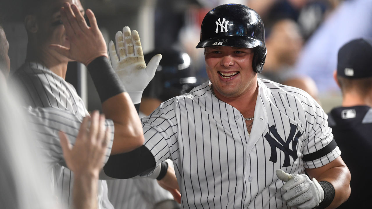 NEW YORK, NEW YORK - JULY 18: Luke Voit #45 of the New York Yankees high-fives his teammates after hitting a home run during the fifth inning of game two of a doubleheader against the Tampa Bay Rays at Yankee Stadium on July 18, 2019 in the Bronx borough of New York City.