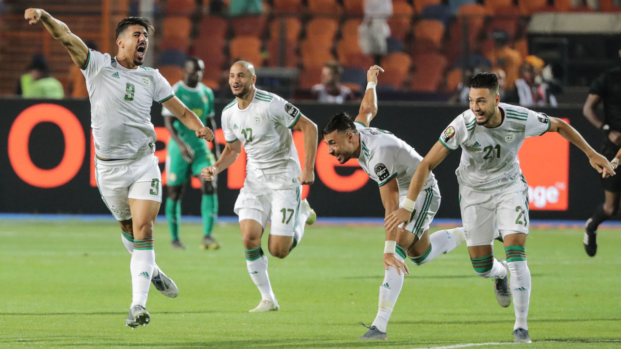 19 July 2019, Egypt, Cairo: Algeria's Baghdad Bounedjah (L) celebrates with teammates Adlene Guedioura (2-L), Ramy Bensebaini (R) and Youcef Belaili after scoring his side's first goal during the 2019 Africa Cup of Nations final soccer match between Senegal and Algeria at the Cairo International Stadium. Photo: Oliver Weiken/dpa