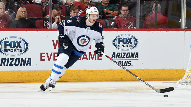 GLENDALE, AZ - FEBRUARY 24: Jacob Trouba #8 of the Winnipeg Jets skates the puck up ice against the Arizona Coyotes at Gila River Arena on February 24, 2019 in Glendale, Arizona.