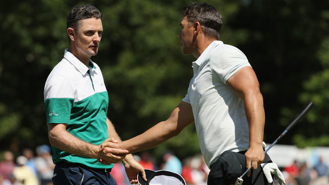 NORTON, MA - SEPTEMBER 01: Justin Rose of England shakes hands with Brooks Koepka of the United States after finishing on the ninth green during round two of the Dell Technologies Championship at TPC Boston on September 1, 2018 in Norton, Massachusetts.