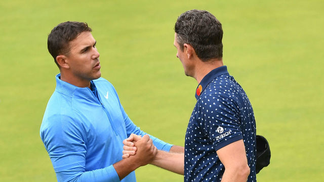 US golfer Brooks Koepka (L) shakes hands with England's Justin Rose after completing the third round of the British Open golf Championships at Royal Portrush golf club in Northern Ireland on July 20, 2019.