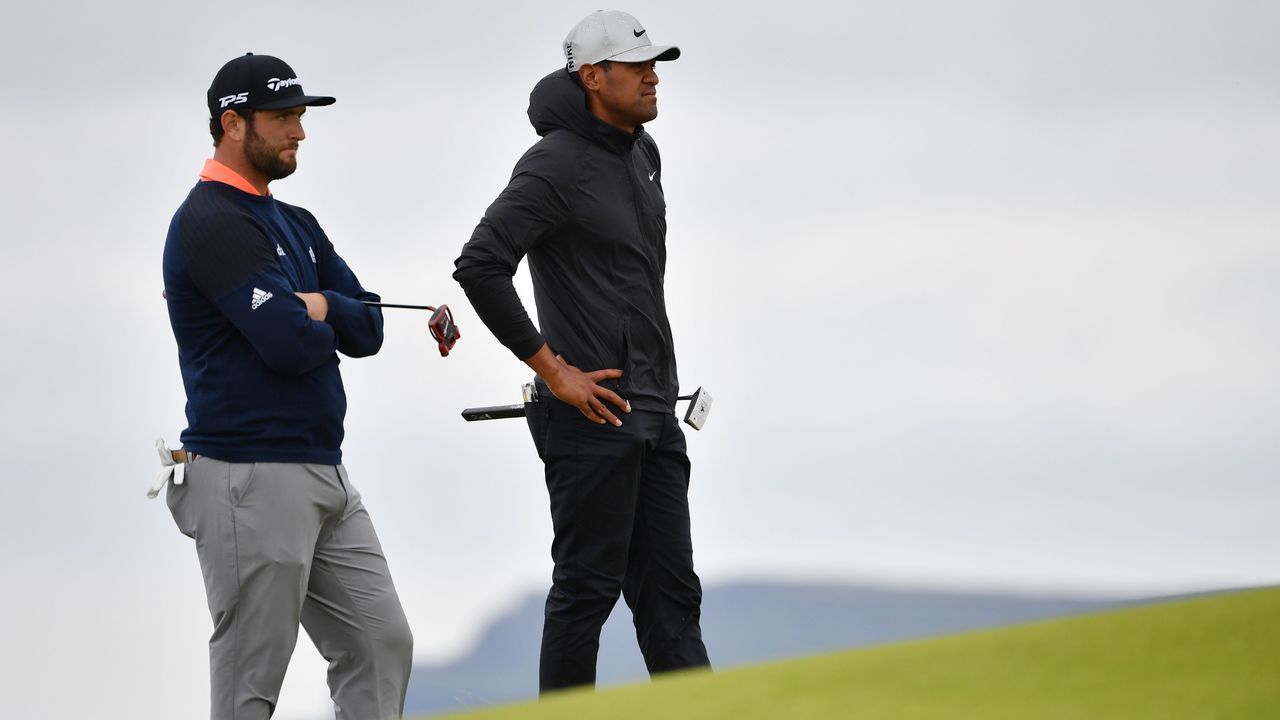 US golfer Tony Finau (R) and Spain's Jon Rahm stand on the 5th green during the final round of the British Open golf Championships at Royal Portrush golf club in Northern Ireland on July 21, 2019.