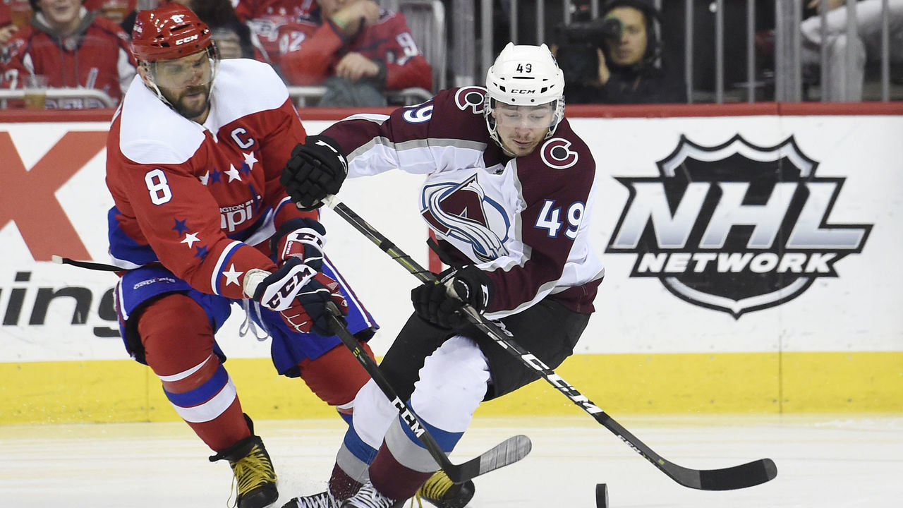 WASHINGTON, DC - FEBRUARY 07: Samuel Girard #49 of the Colorado Avalanche and Alex Ovechkin #8 of the Washington Capitals battle for the puck in the first period at Capital One Arena on February 7, 2019 in Washington, DC.