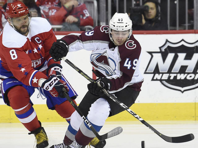 WASHINGTON, DC - FEBRUARY 07: Samuel Girard #49 of the Colorado Avalanche and Alex Ovechkin #8 of the Washington Capitals battle for the puck in the first period at Capital One Arena on February 7, 2019 in Washington, DC.