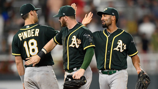 MINNEAPOLIS, MN - JULY 19: (L-R) Chad Pinder #18, Robbie Grossman and Marcus Semien #10 of the Oakland Athletics celebrate defeating the Minnesota Twins after the game on July 19, 2019 at Target Field in Minneapolis, Minnesota. The Athletics defeated the Twins 5-3.