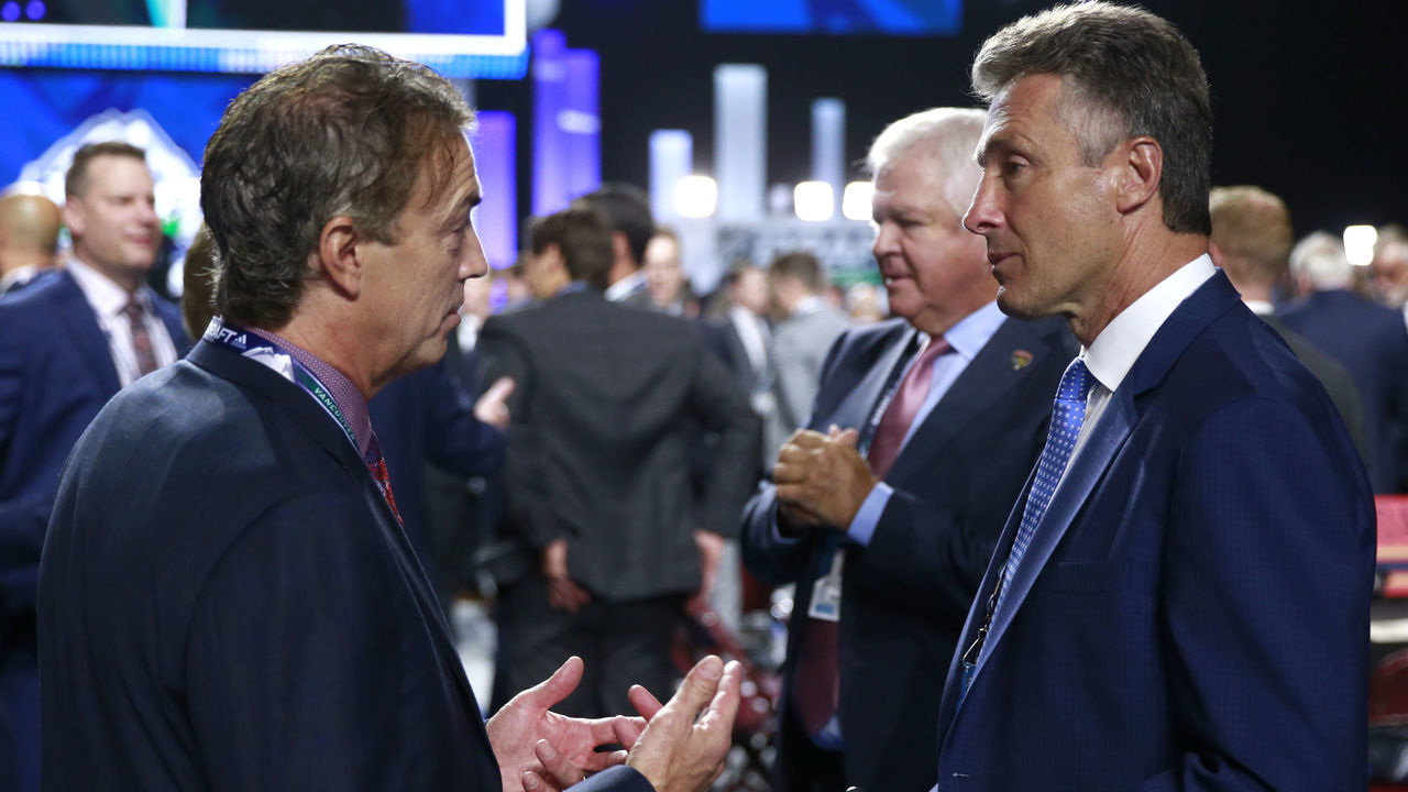 VANCOUVER, BRITISH COLUMBIA - JUNE 21: General managers Joe Sakic of the Colorado Avalanche (L) and Doug Wilson of the San Jose Sharks talk on the draft floor during the first round of the 2019 NHL Draft at Rogers Arena on June 21, 2019 in Vancouver, Canada.