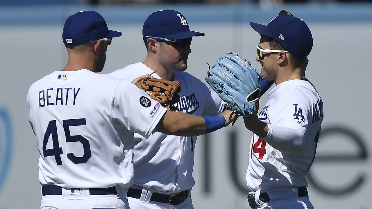 LOS ANGELES, CA - JULY 21: A.J. Pollock #11, Matt Beaty #45 and Enrique Hernandez #14 of the Los Angeles Dodgers celebrate after shutting out the Marlins, 9-0, at Dodger Stadium on July 21, 2019 in Los Angeles, California.