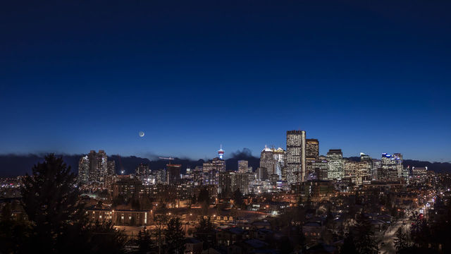 The waxing crescent Moon over the skyline of Calgary on January 18, 2018 I shot this from Tom Campbell Park area looking southwest to the sunset twilight This is a 2-segment panorama, each segment being a 7-image HDR stack, all blended with Adobe Camera Raw Shot with the 50mm lens and Canon 6D MkII. (Photo by: VW Pics/Universal Images Group via Getty Images)