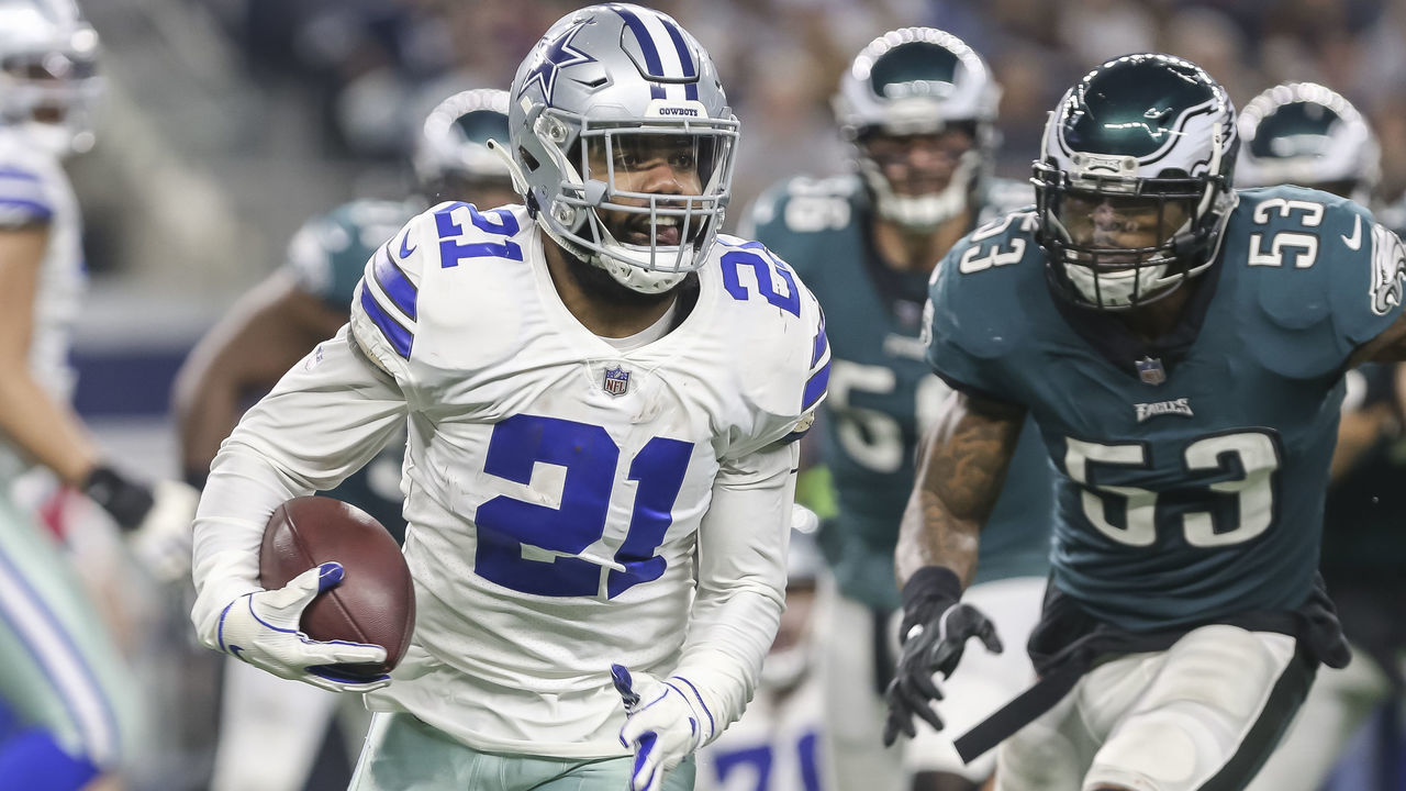 ARLINGTON, TX - DECEMBER 09: Dallas Cowboys running back Ezekiel Elliott (21) runs through the line of scrimmage during the game between the Dallas Cowboys and the Philadelphia Eagles on December 9, 2018 at AT&T Stadium in Arlington. Texas. Dallas defeats Philadelphia 29-23 in overtime.
