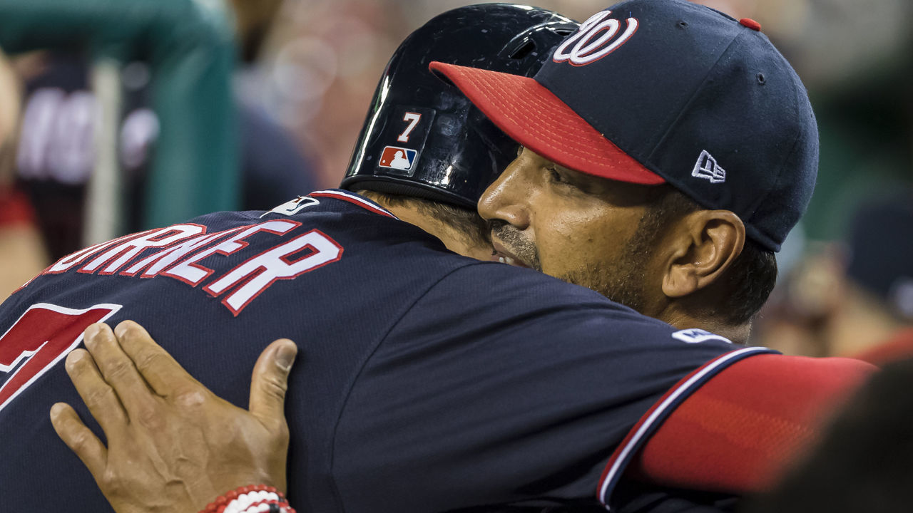 WASHINGTON, DC - JULY 23: Manager Dave Martinez #4 of the Washington Nationals congratulates Trea Turner #7 for hitting the cycle against the Colorado Rockies during the seventh inning against the Colorado Rockies at Nationals Park on June 23, 2019 in Washington, DC.