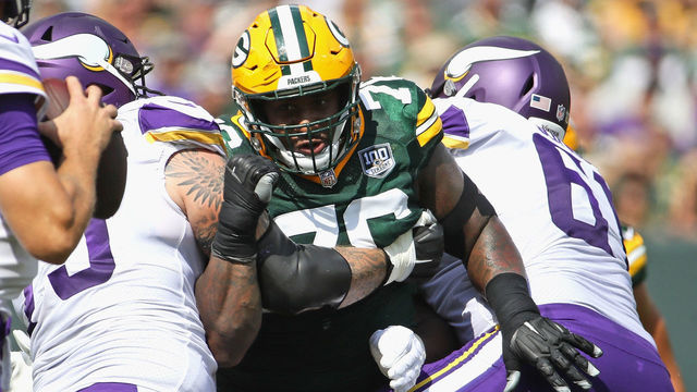 GREEN BAY, WI - SEPTEMBER 16: Mike Daniels #76 of the Green Bay Packers rushes against Pat Elflein #65 (L) and Brett Jones #61 of the Minnesota Vikings at Lambeau Field on September 16, 2018 in Green Bay, Wisconsin. The Vikings and the Packers tied 29-29 after overtime.