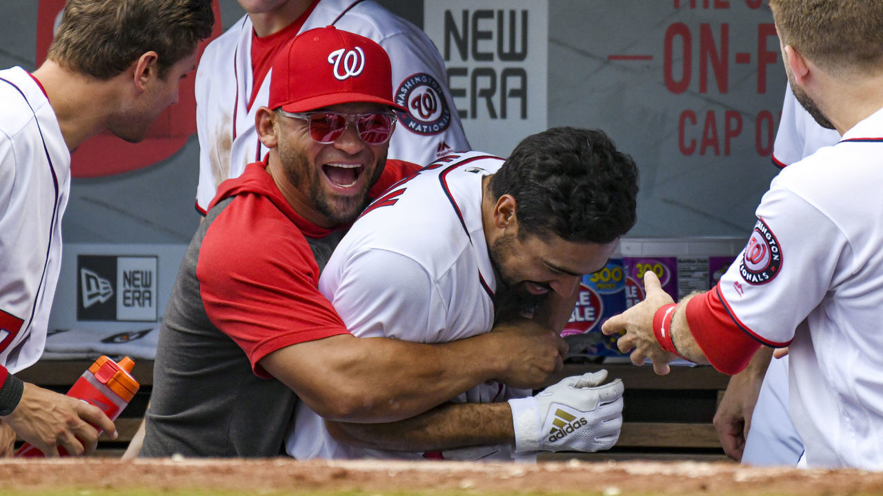 WASHINGTON, DC - JULY 24: Washington Nationals third baseman Anthony Rendon (6) is congratulated by center fielder Gerardo Parra (88) in the dugout after his game winning home run in the seventh inning during the game between the Colorado Rockies and the Washington Nationals on July 24, 2019, at Nationals Park, in Washington D.C.