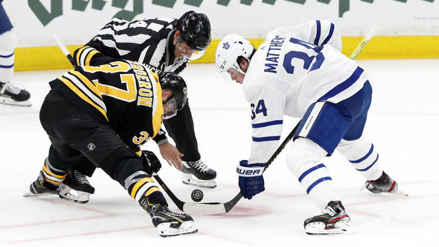 BOSTON, MA - APRIL 19: Boston Bruins center Patrice Bergeron (37) and Toronto Maple Leafs center Auston Matthews (34) take a face off during Game 5 of the First Round Stanley Cup Playoffs between the Boston Bruins and the Toronto Maple Leafs on April 19, 2019, at TD garden in Boston, Massachusetts.