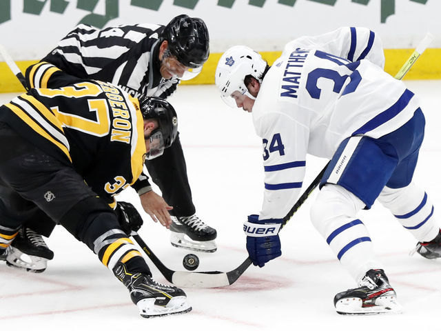BOSTON, MA - APRIL 19: Boston Bruins center Patrice Bergeron (37) and Toronto Maple Leafs center Auston Matthews (34) take a face off during Game 5 of the First Round Stanley Cup Playoffs between the Boston Bruins and the Toronto Maple Leafs on April 19, 2019, at TD garden in Boston, Massachusetts.