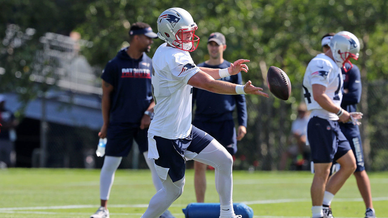 FOXBOROUGH, MA - JULY 25: New England Patriots' Danny Etling, listed as a quarterback but who was working out as a receiver today, drops a pass during the first workout at Patriots training camp at Gillette Stadium in Foxborough, MA on July 25, 2019. Wide receivers Dontrelle Inman (15, left) and Braxton Berrios (14, right) are also pictured.