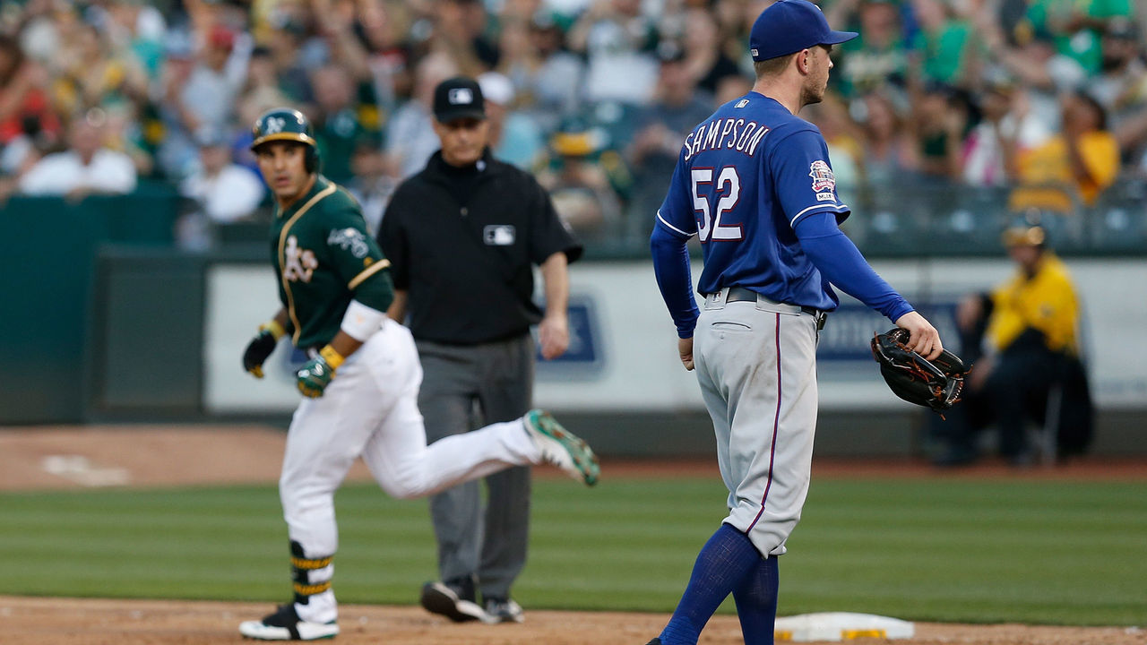 OAKLAND, CALIFORNIA - JULY 27: Ramon Laureano #22 of the Oakland Athletics has words with pitcher Adrian Sampson #52 of the Texas Rangers after hitting a solo home run in the bottom of the sixth inning at Ring Central Coliseum on July 27, 2019 in Oakland, California.