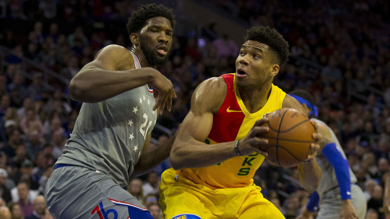 PHILADELPHIA, PA - APRIL 04: Giannis Antetokounmpo #34 of the Milwaukee Bucks controls the ball against Joel Embiid #21 of the Philadelphia 76ers in the first quarter at the Wells Fargo Center on April 4, 2019 in Philadelphia, Pennsylvania.