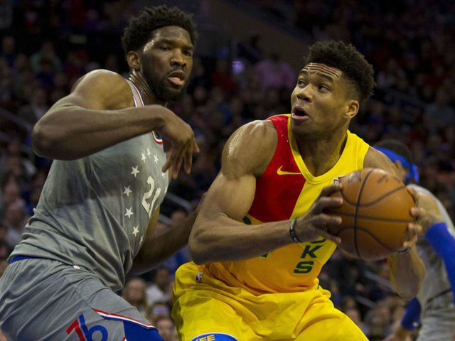 PHILADELPHIA, PA - APRIL 04: Giannis Antetokounmpo #34 of the Milwaukee Bucks controls the ball against Joel Embiid #21 of the Philadelphia 76ers in the first quarter at the Wells Fargo Center on April 4, 2019 in Philadelphia, Pennsylvania.