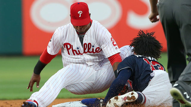 PHILADELPHIA, PA - JULY 26: Ronald Acuna Jr. #13 of the Atlanta Braves slides safely into second base with a stolen base and slams his face into the knee of shortstop Jean Segura #2 of the Philadelphia Phillies during the first inning of a game against the Philadelphia Phillies at Citizens Bank Park on July 26, 2019 in Philadelphia, Pennsylvania. The Braves defeated the Phillies 9-2.