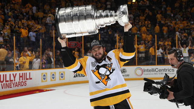 NASHVILLE, TN - JUNE 11: Chris Kunitz #14 of the Pittsburgh Penguins lifts the Stanley Cup over his head after Game Six of the 2017 NHL Stanley Cup Final at the Bridgestone Arena on June 11, 2017 in Nashville, Tennessee. The Penguins defeated the Predators 2-0. The Pittsburgh Penguins win the Stanley Cup Final series against the Nashville Predators 4-2.
