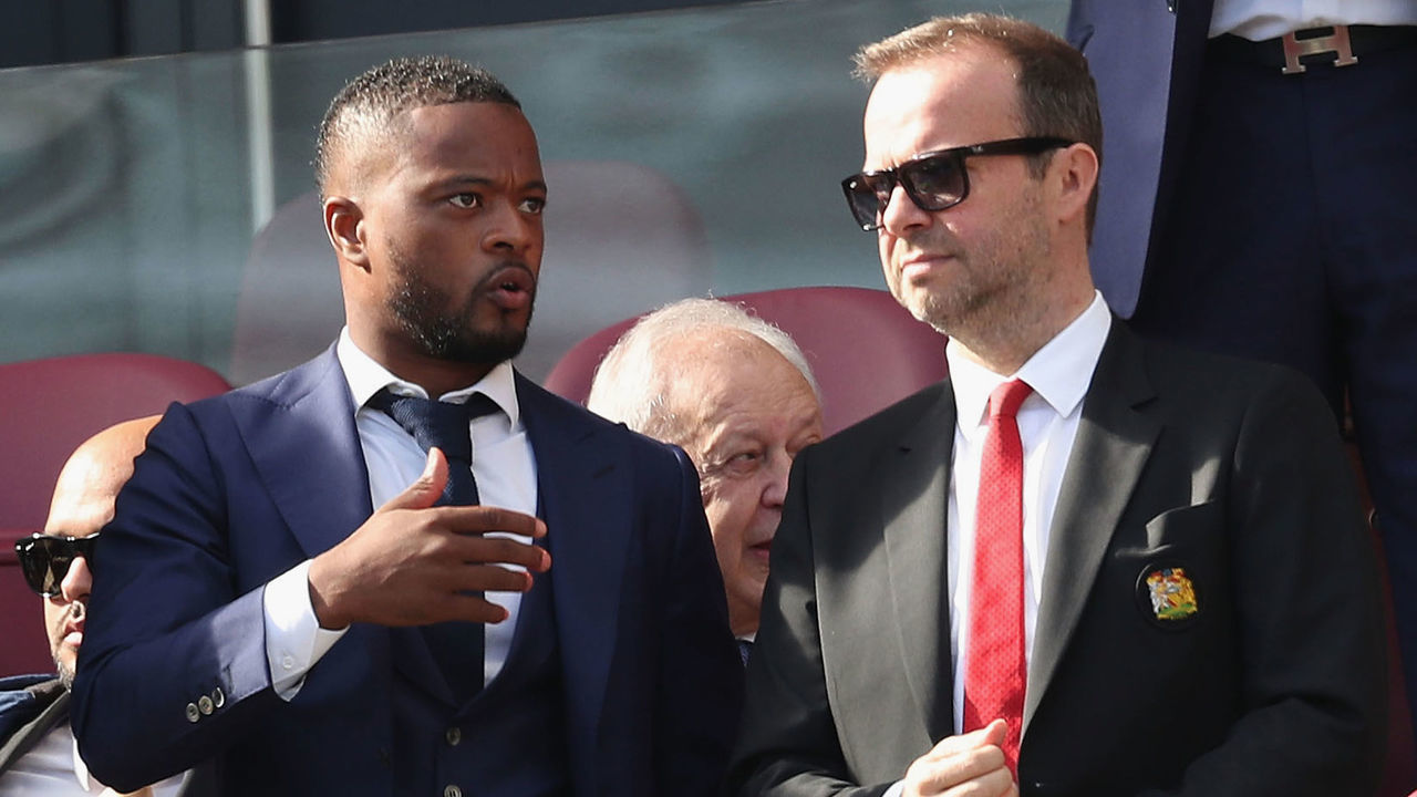 LONDON, ENGLAND - SEPTEMBER 29: Executive Vice Chairman Ed Woodward of Manchester United talks to former player Patrice Evra ahead of the Premier League match between West Ham United and Manchester United at London Stadium on September 29, 2018 in London, United Kingdom.